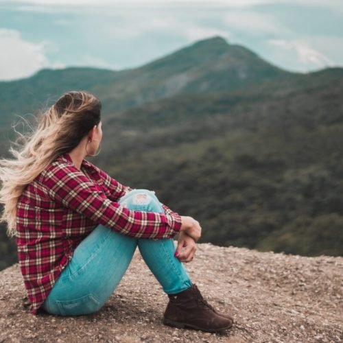 Photo by Luis Fernandes: https://www.pexels.com/photo/side-view-photo-of-woman-sitting-on-ground-overlooking-a-hill-2422854/