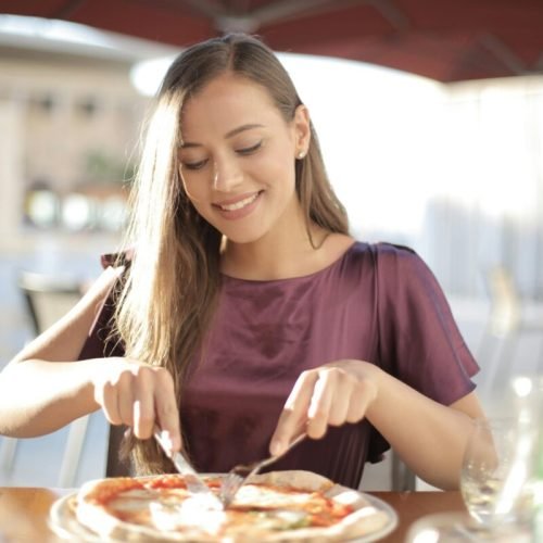 Photo by Andrea Piacquadio: https://www.pexels.com/photo/woman-in-purple-top-while-slicing-pizza-3811604/