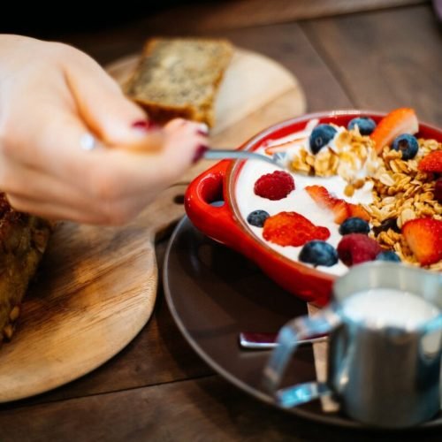 Photo by Flo Dahm on <a href="https://www.pexels.com/photo/person-holding-spoon-and-round-red-ceramic-bowl-with-pastries-1065030/" rel="nofollow">Pexels.com</a>