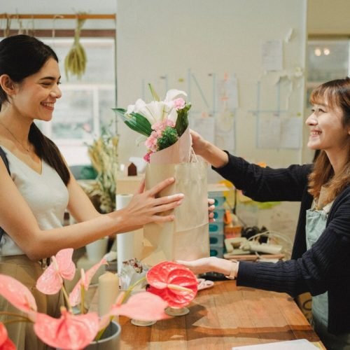 Photo by Amina Filkins on <a href="https://www.pexels.com/photo/happy-florist-giving-bouquet-of-flowers-to-lady-5413724/" rel="nofollow">Pexels.com</a>