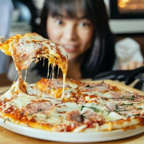 Photo by Katerina Holmes on <a href="https://www.pexels.com/photo/women-taking-piece-of-pizza-with-tomatoes-and-cheese-5907901/" rel="nofollow">Pexels.com</a>