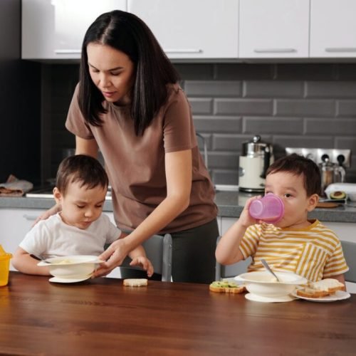 Photo by Jep Gambardella on <a href="https://www.pexels.com/photo/a-woman-in-brown-shirt-taking-care-of-her-kids-in-the-kitchen-6212710/" rel="nofollow">Pexels.com</a>