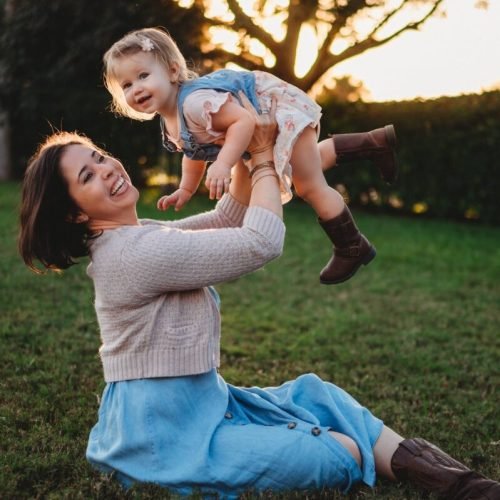 Photo by Lauren  Brown on <a href="https://www.pexels.com/photo/excited-woman-raising-cute-daughter-on-hands-in-garden-6301968/" rel="nofollow">Pexels.com</a>
