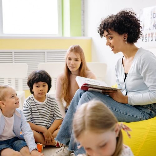 Photo by Yan Krukov on <a href="https://www.pexels.com/photo/woman-reading-a-book-to-the-children-8613089/" rel="nofollow">Pexels.com</a>