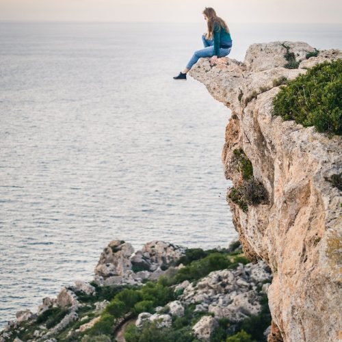 Photo by Lukas Hartmann on <a href="https://www.pexels.com/photo/woman-sitting-on-mountain-887173/" rel="nofollow">Pexels.com</a>