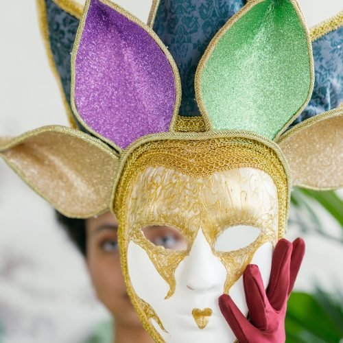 Photo by Mikhail Nilov on <a href="https://www.pexels.com/photo/woman-holding-a-mardi-gras-full-face-mask-9392056/" rel="nofollow">Pexels.com</a>